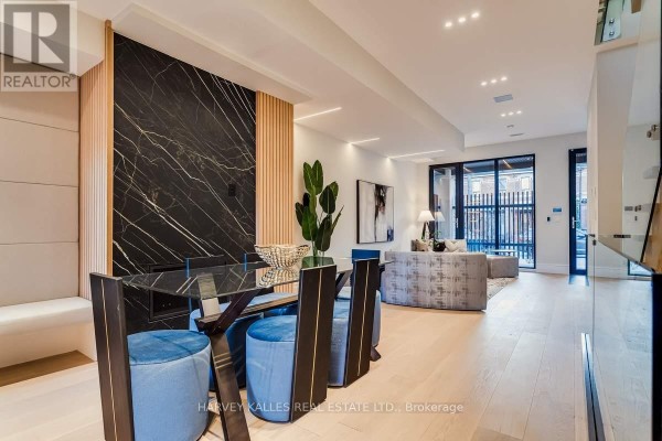 Glass dining table & blue stools, marble accent wall, sofa - 179 Palmerston Avenue Toronto