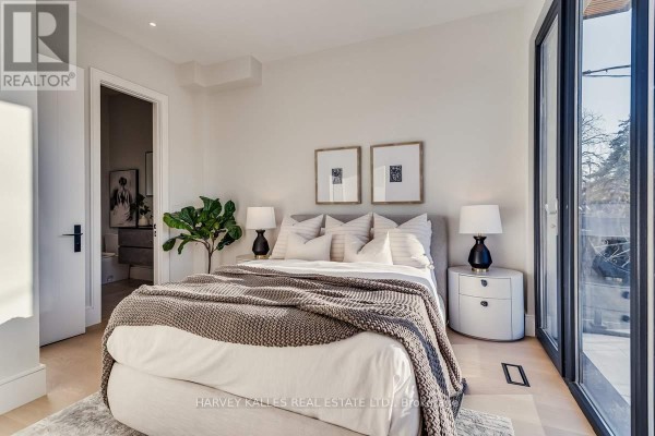 King-size bed with modern nightstands and artwork - 179 Palmerston Avenue Toronto