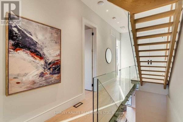 Modern hallway with abstract art, glass railing, and floating staircase - 179 Palmerston Avenue Toronto