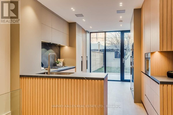 Modern kitchen with wood island and sleek cabinetry - 179 Palmerston Avenue Toronto
