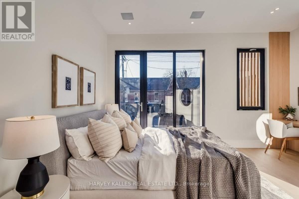 Modern bedroom with king bed, glass doors, desk area - 179 Palmerston Avenue Toronto