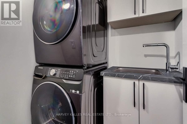 Stacked Samsung washer and dryer, utility sink with marble countertop - 179 Palmerston Avenue Toronto