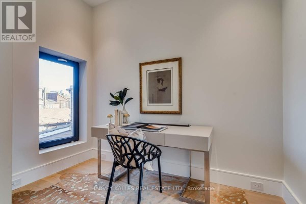 Modern office with desk, chair, artwork, and large window - 179 Palmerston Avenue Toronto