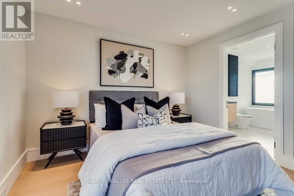 Bedroom with tufted headboard, artwork, and ensuite bathroom - 179 Palmerston Avenue Toronto