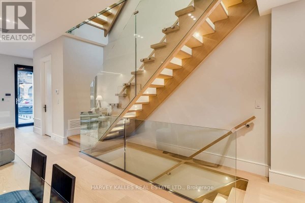Floating wood stairs with glass railings and recessed lighting - 179 Palmerston Avenue Toronto