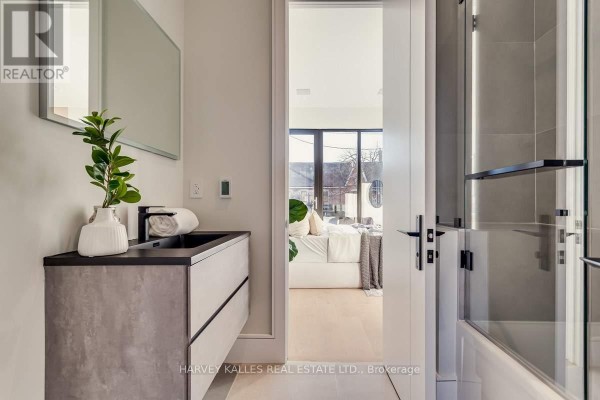 Modern floating vanity, black sink, and glass shower - 179 Palmerston Avenue Toronto