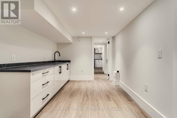 Modern kitchen with white cabinets and dark counters - 179 Palmerston Avenue Toronto