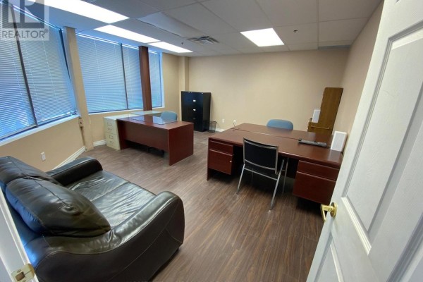 Office space with two desks, chairs, a leather couch, and large windows. - 18 - 60 West Wilmot Street, Richmond Hill