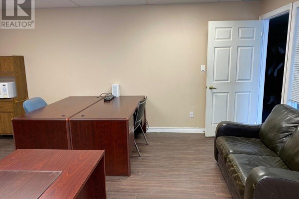 Office space with two desks, chairs, a leather couch, and a door. - 18 - 60 West Wilmot Street, Richmond Hill