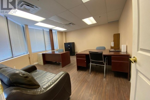 Office space with two desks, chairs, a leather couch, and filing cabinets. - 18 - 60 West Wilmot Street, Richmond Hill