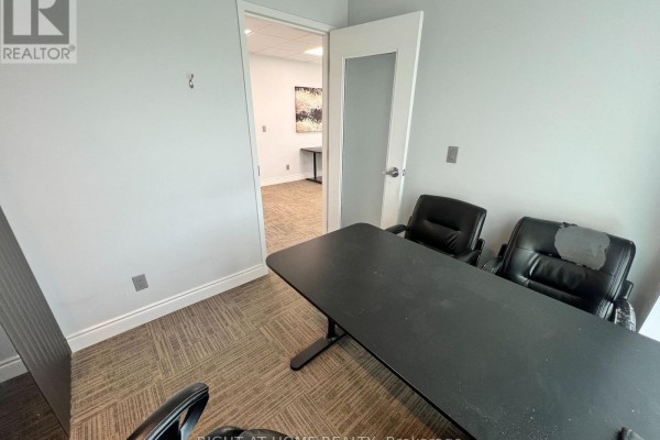 View through an open door into an adjacent office with desks and chairs. - 18 2nd - 120 Woodstream Boulevard, Vaughan