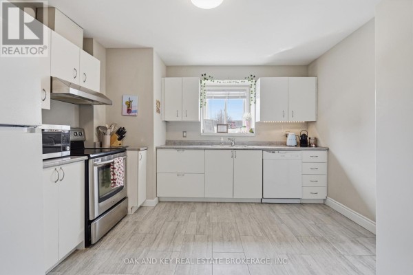 White cabinetry, stainless steel appliances, tile floor kitchen - 18 Chapman Court London North