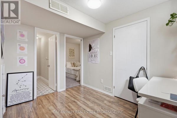 Hallway with wood-look flooring, posters, desk, and chair - 18 Chapman Court London North