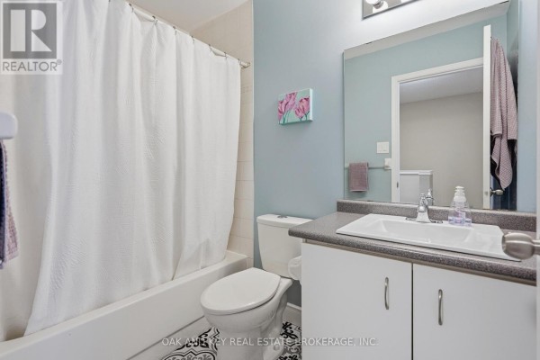 Bathtub, toilet, vanity, and sink in a bathroom - 18 Chapman Court London North