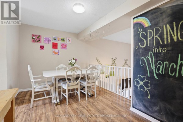 White dining table with chairs, chalkboard wall, and wood floor - 18 Chapman Court London North