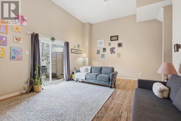 Living room with vaulted ceiling, sofas, rug, and sliding door - 18 Chapman Court London North