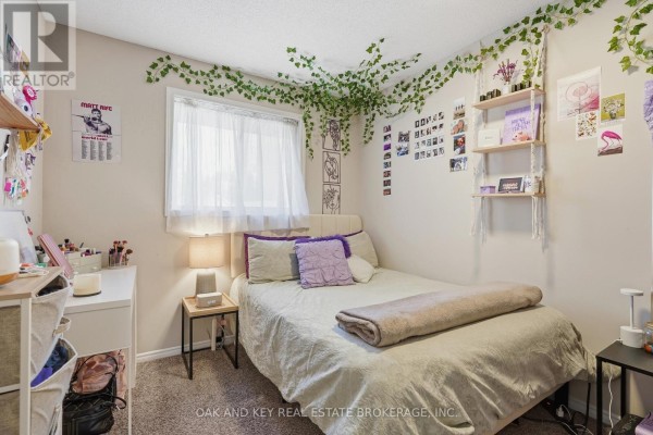 Bedroom with bed, desk, ivy decor, and wall photos - 18 Chapman Court London North