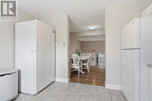 Kitchen with two refrigerators and dining area - 18 Chapman Court London North