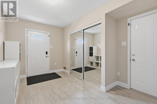 Hallway with mirrored closet and tile flooring - 18 Chapman Court London North