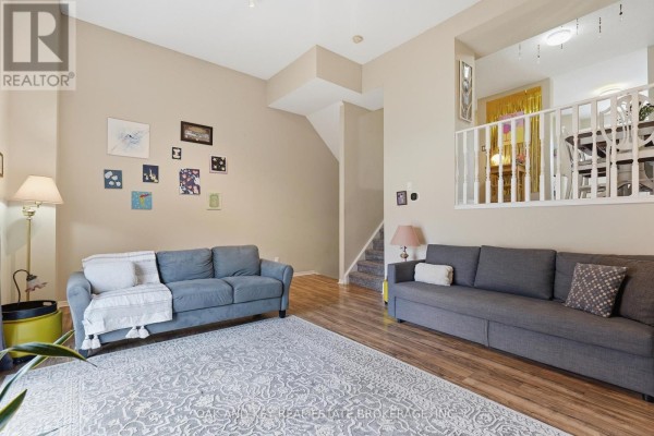 Living room with sofas and area rug, stairs to dining area - 18 Chapman Court London North