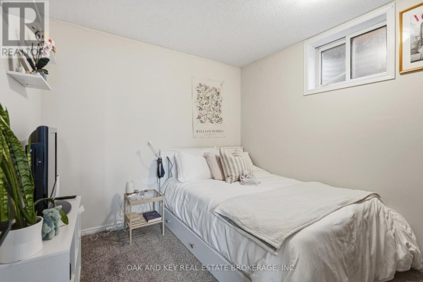 Bedroom with queen bed, nightstand, TV, and wall art - 18 Chapman Court London North