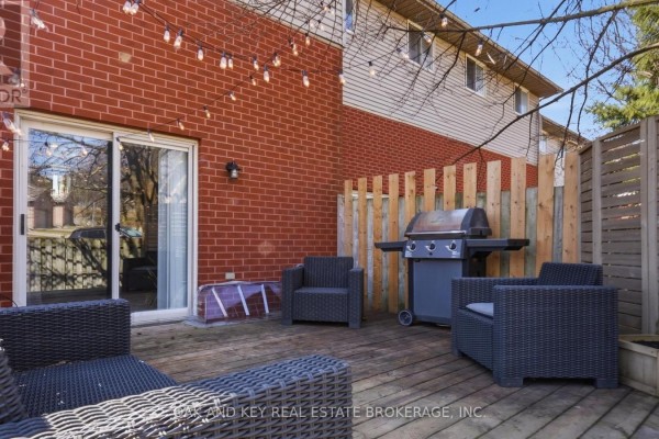Outdoor deck with wicker furniture, gas grill, and string lights - 18 Chapman Court London North