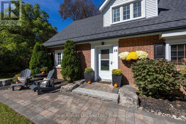 Bird's-eye view of the backyard with snow, patio area, and surrounding trees. - 18 Concession Street W, Clarington