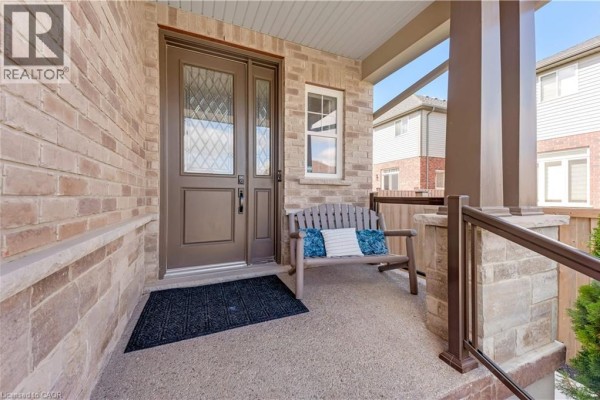 Covered front porch with a wooden bench and double entry doors made of glass and wood. - 18 Crossbridge Avenue, Kitchener