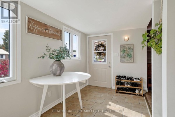 Foyer with a white half-round table, shoe rack, and light beige walls. - 18 Frost Avenue, South Stormont