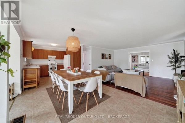 Open-concept living, dining, and kitchen area with tile and wood floors. - 18 Frost Avenue, South Stormont