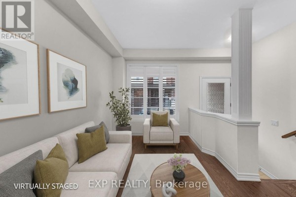 Living room with sofa, armchair, coffee table, staircase, and window with blinds. - 18 Hough Lane, Ajax