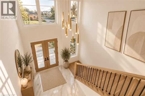 View from above of the entryway showing double front doors, high ceiling, and modern chandelier. - 18 Miles Road, Hamilton
