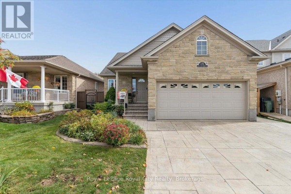 View of the property from the left, showing the front porch with railings and landscaping. - 18 Mullin Drive, Guelph