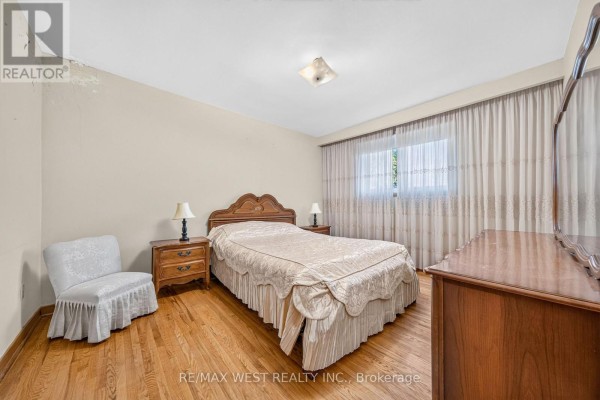 Bedroom with queen bed, wooden dresser, nightstands, chair, and curtains. - 18 Pheasant Valley Court, Markham