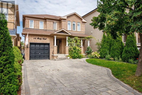 Front exterior view of a detached brick house with manicured landscaping and a paved driveway. - 18 Rusty Trail, Vaughan