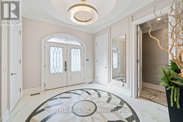 Spacious living room with marble flooring, large windows, and modern decor. - 18 Suncrest Drive, Toronto