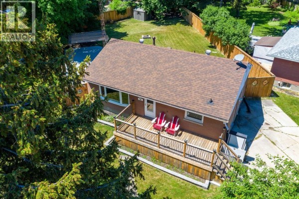 Aerial view of the house featuring a wooden deck and grassy yard - 18 Tweedsmuir Avenue, Sarnia