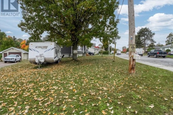View of the street from the property, showing neighboring houses and vehicles. - 18 Wickwas Street, Onaping