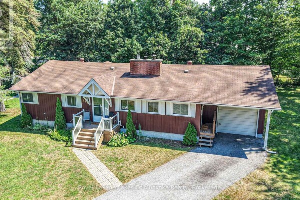 Front view of a brown bungalow with a brick chimney, covered porch, and attached garage. - 180 Lofty Pines Crescent, Gravenhurst)