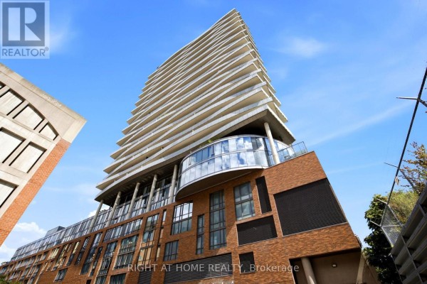 Low-angle exterior view of a modern condominium building with balconies. - 1801 - 1 Market Street, Toronto