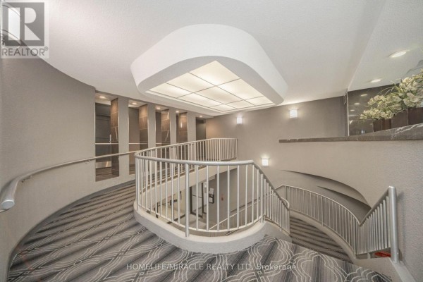 Curved staircase with patterned carpet and modern lighting - 1802 - 8 Lisa Street Brampton