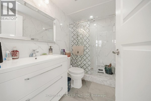 Bathroom with vanity, large mirror, and glass shower - 1802 - 8 Lisa Street Brampton