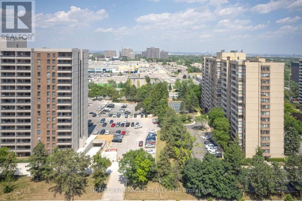 Apartment buildings, parking lot, tennis court, and cityscape - 1802 - 8 Lisa Street Brampton