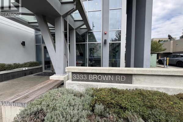 Close-up of 3333 Brown Road address sign with concrete planter and seating. - 1802 3333 Brown Road, Richmond