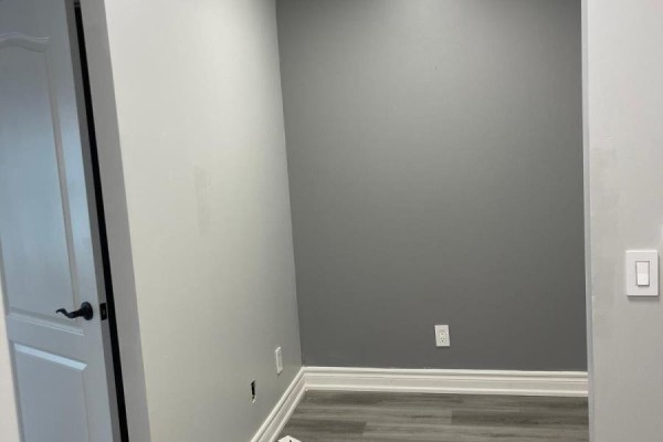 Empty room with grey walls and white baseboards, viewed from doorway. - 1805 - 70 Town Centre Court, Toronto