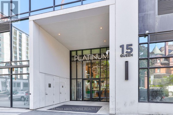 Entrance of 15 Queen with the name 'PLATINUM' displayed prominently and glass doors. - 1806 - 15 Queen Street, Hamilton