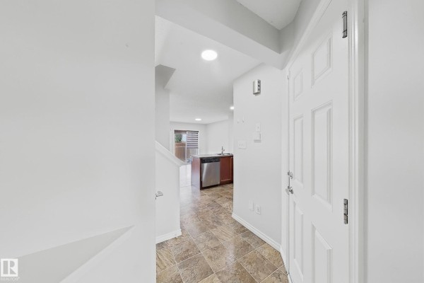 Main floor interior view showing entry, closet, and open-concept living area with kitchen. - 1806 28 St Nw Nw, Edmonton