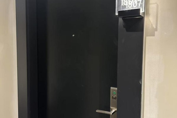 Close-up of a dark, modern apartment door with the number 1807 above. - 1807 - 290 Adelaide Street W, Toronto