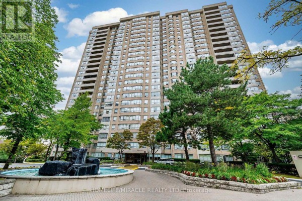 Exterior view of a tall, light-brown brick apartment building with many windows. - 1809 - 30 Malta Avenue, Brampton