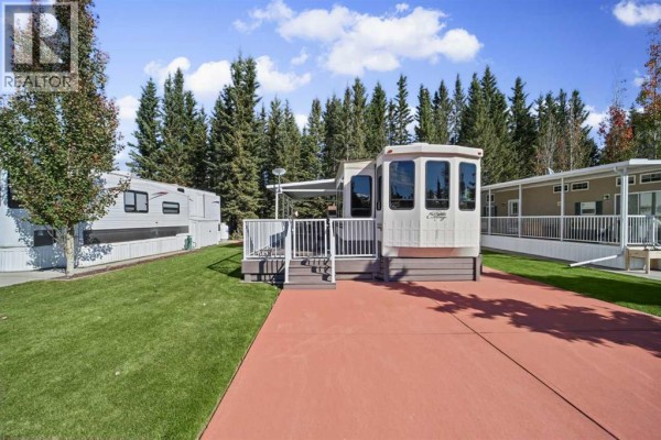View of mobile home from the driveway, flanked by other mobile homes. - 181, 32379 Range Road 55, Rural Mountain View County